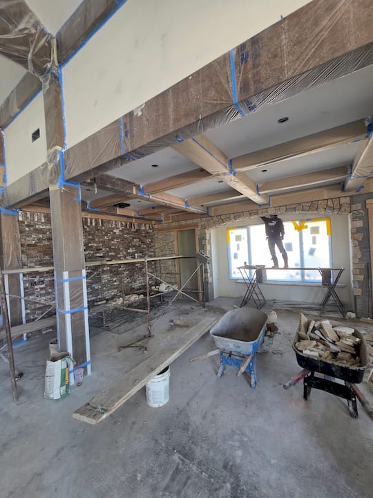 Experienced contractor studies blueprints at construction site